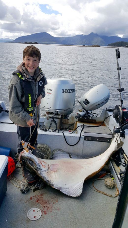 Thomas Barlow with a halibut he caught with the hook he made
