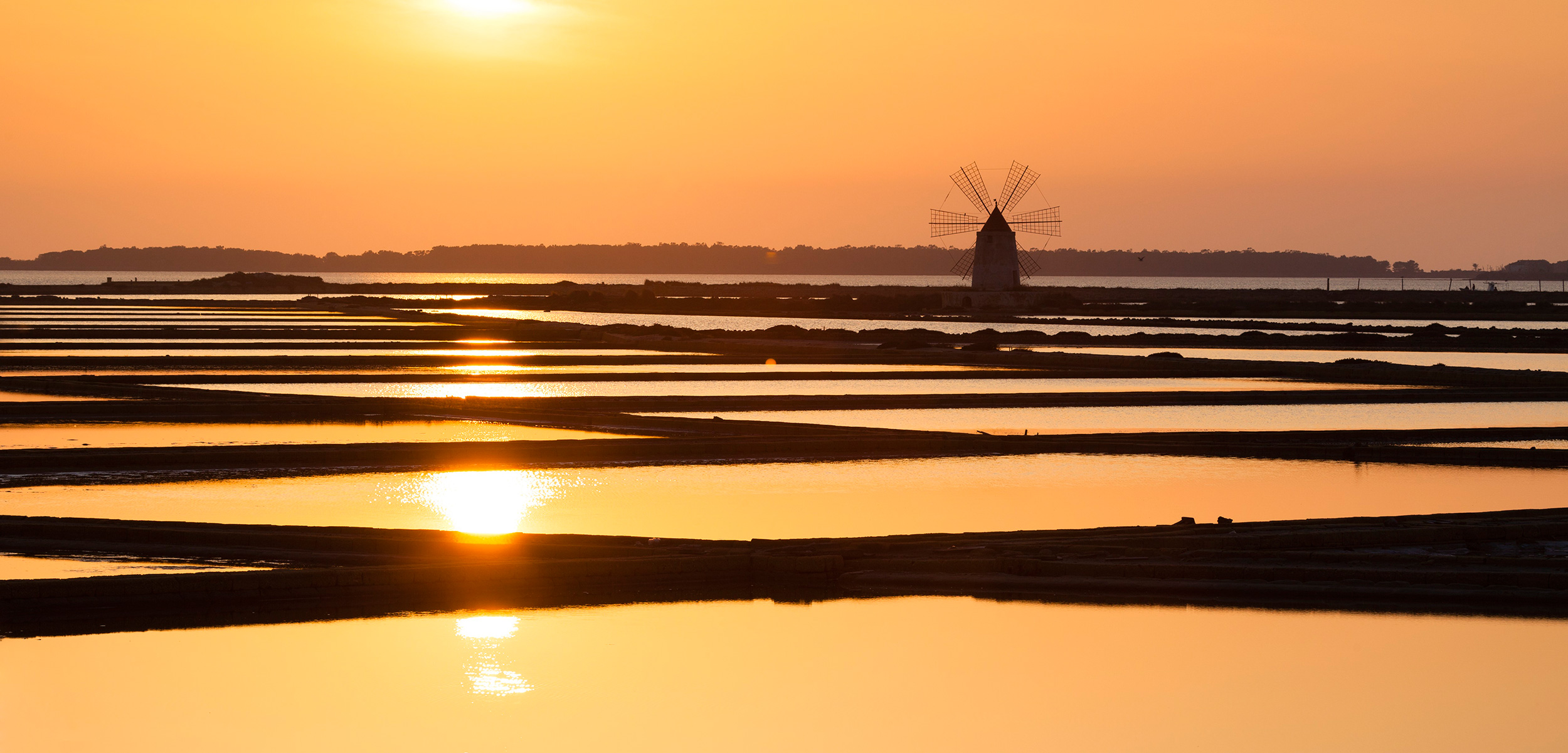 Sunset over the salt flats in Trapani, Sicily. Photo by Frank Lukasseck/Corbis