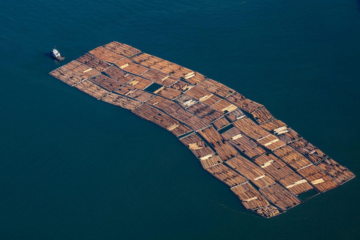 aerial photo of a tug pulling lumber in Howe Sound, British Columbia