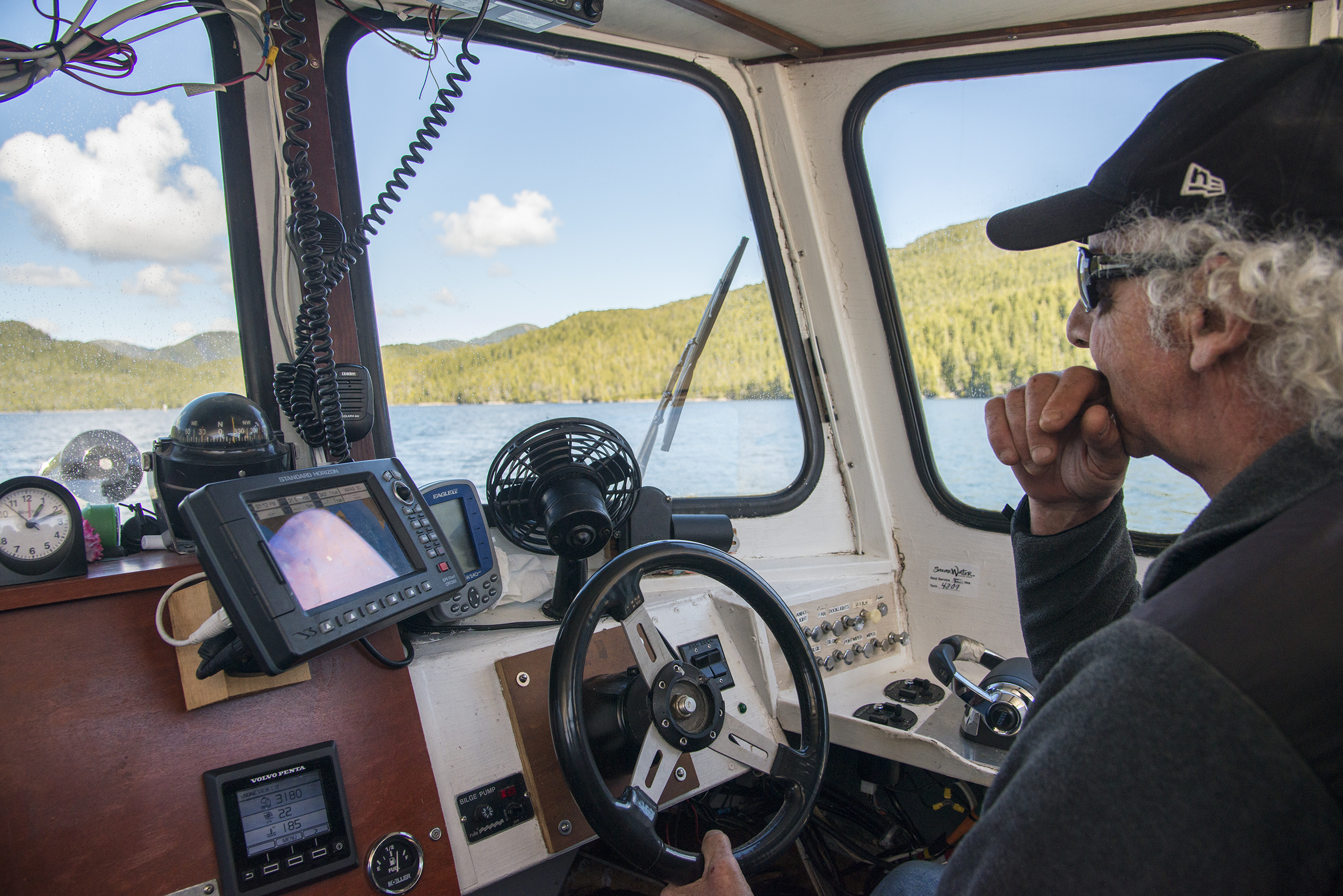 Skipper Bob Martin steers the <em>Northern Lights</em> along British Columbia’s north coast. Photo by Shanna Baker