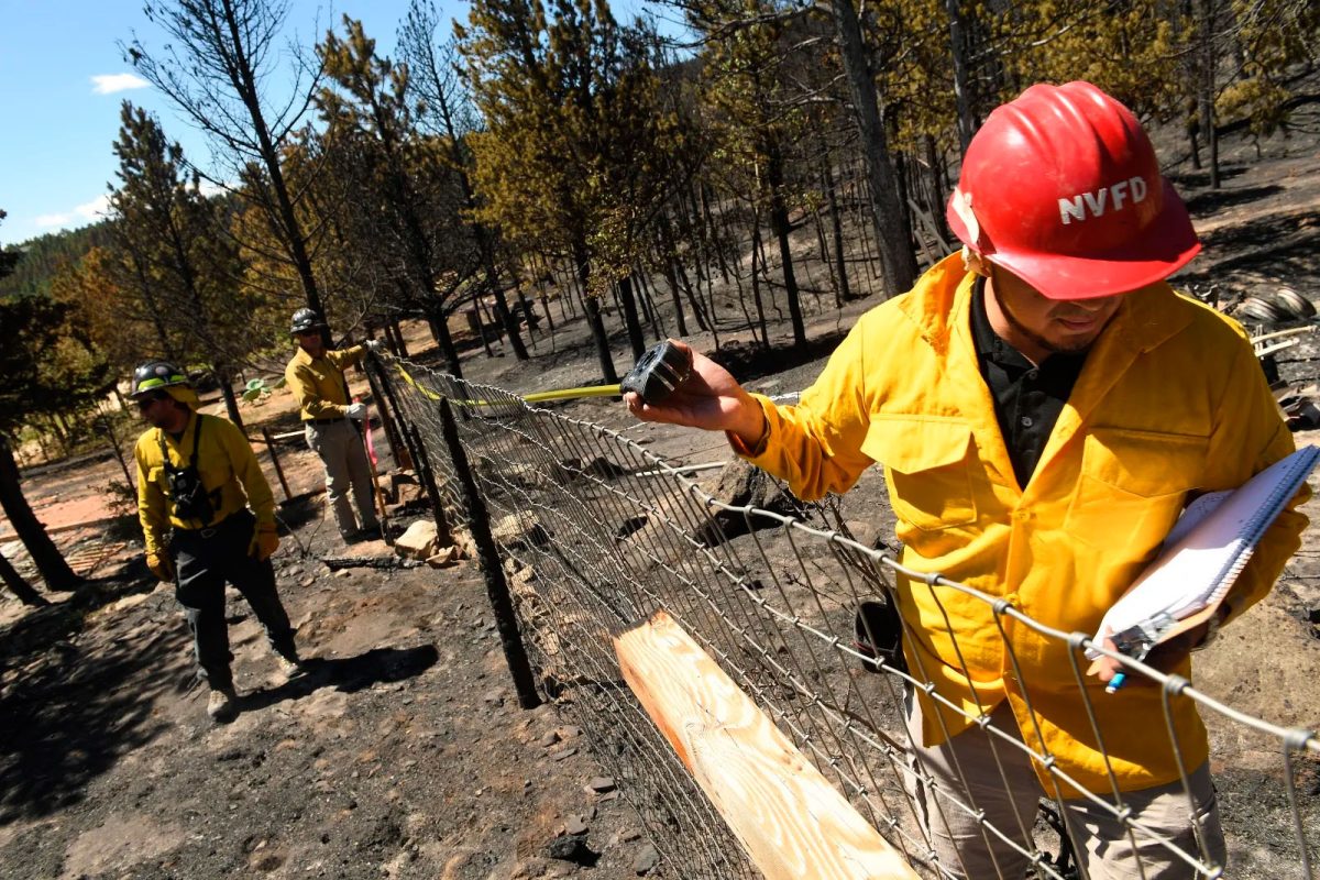 Insurance adjustor Pablo Jimenez tallies property damage in Nederland, Colorado, following a July 2016 wildfire