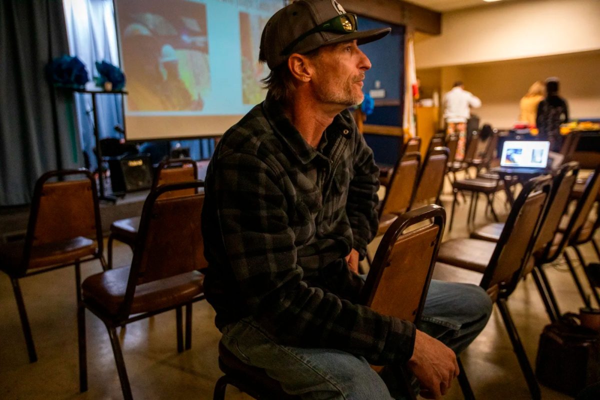 Tobe Magidson of Grizzly Flats, California, sits at a remembrance event to mark the six-month anniversary of the Caldor Fire that destroyed his town