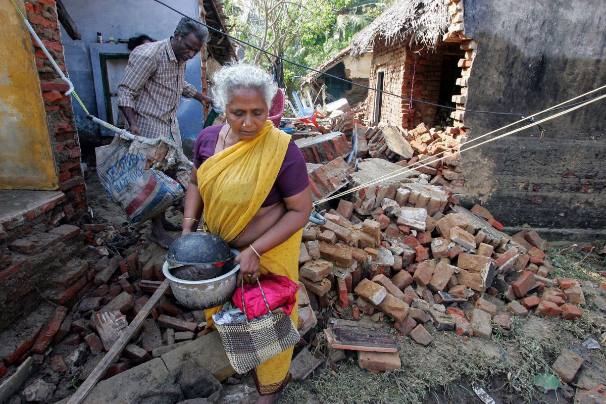 An Indian man and woman salvage belongings from their house in Cuddalore, India after the 2004 tsunami
